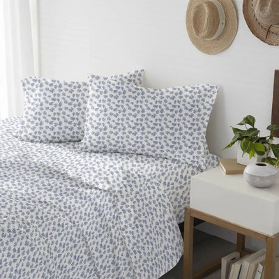 Floral patterned bedding set on a bed.