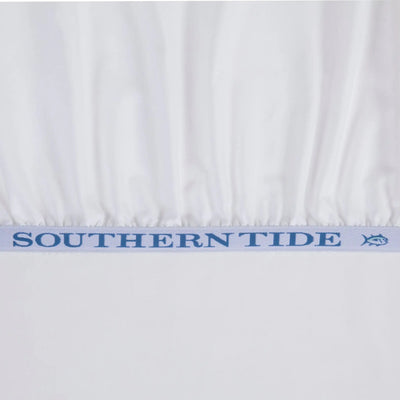 White bed sheet with a light blue elastic band featuring the text 'SOUTHERN TIDE' and a small fish logo.