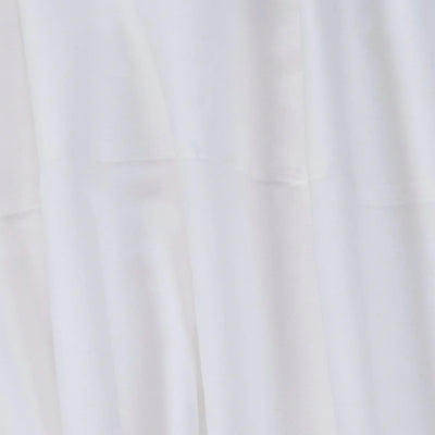 A close-up of white fabric with soft folds and a smooth texture.