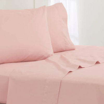 Pink bed sheets and pillowcases on a white background