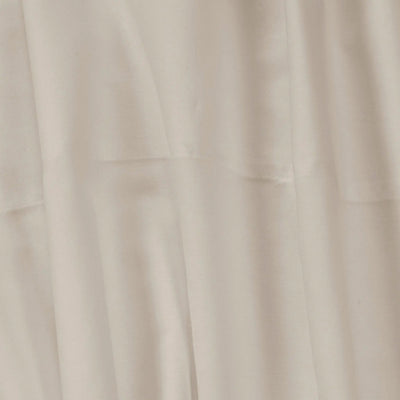 A close-up of draped beige fabric with soft folds and a smooth texture.