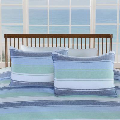 Striped shams on a bed.