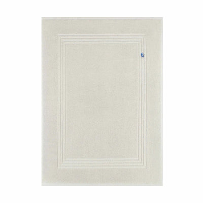 A grey bath mat with a raised double-line border design and a small blue tag on the right side, shown against a plain white background.