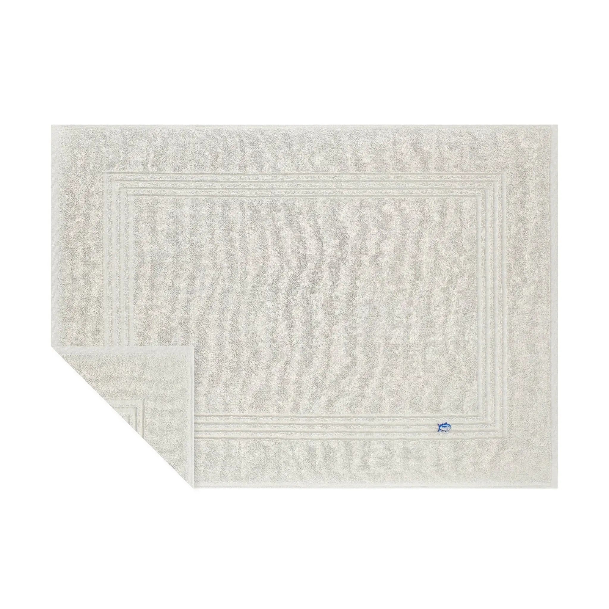 Grey textured bath mat with a brand logo on a white background