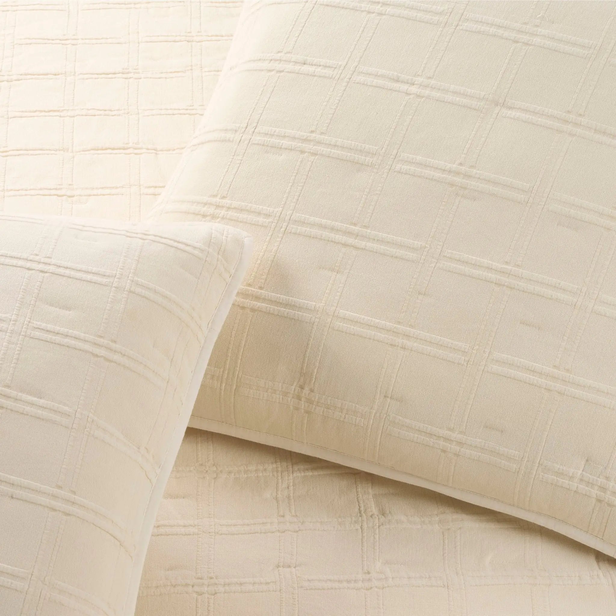 Close-up of ivory textured fabric with a subtle check pattern