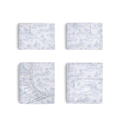 Set of four blue and white patterned bed sheets on a white background