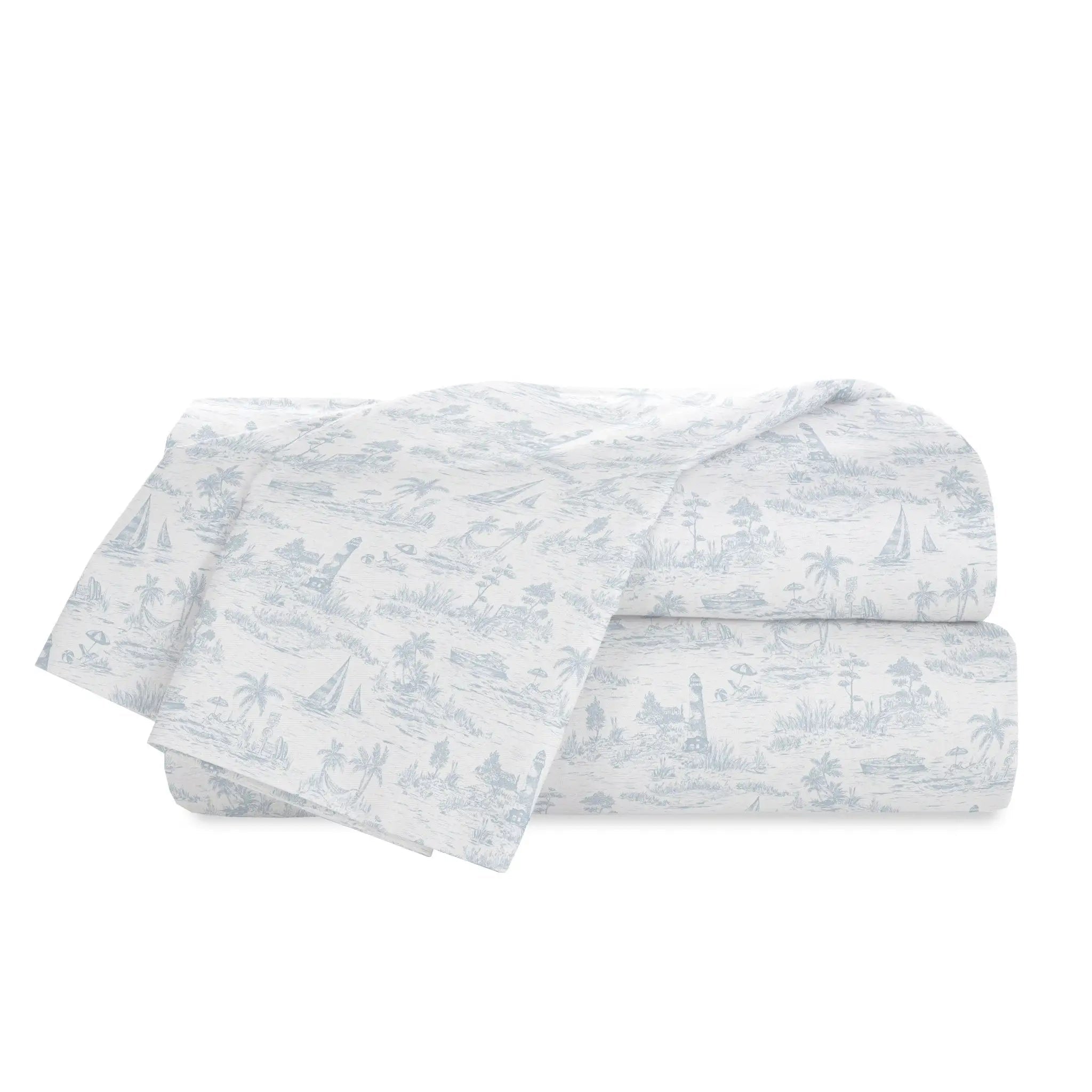 Folded white bedding or fabric set with a light blue toile-style landscape print, shown on a plain white background.