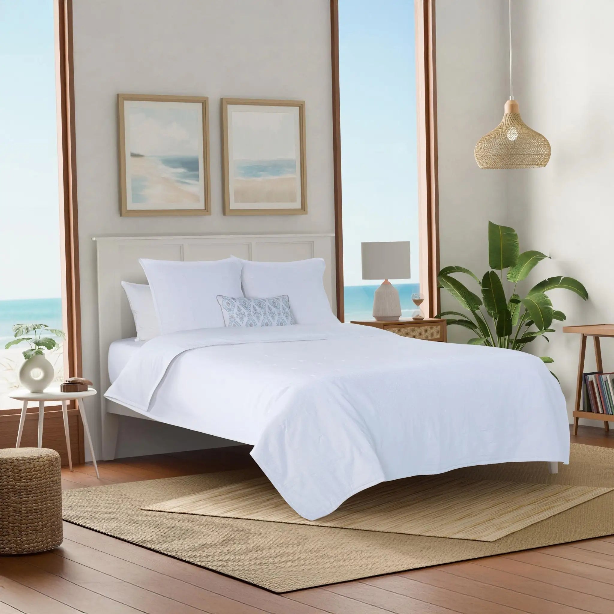 Modern bedroom with a white quilt and euros.