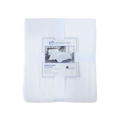 Back view of white quilt with packaging on a white background