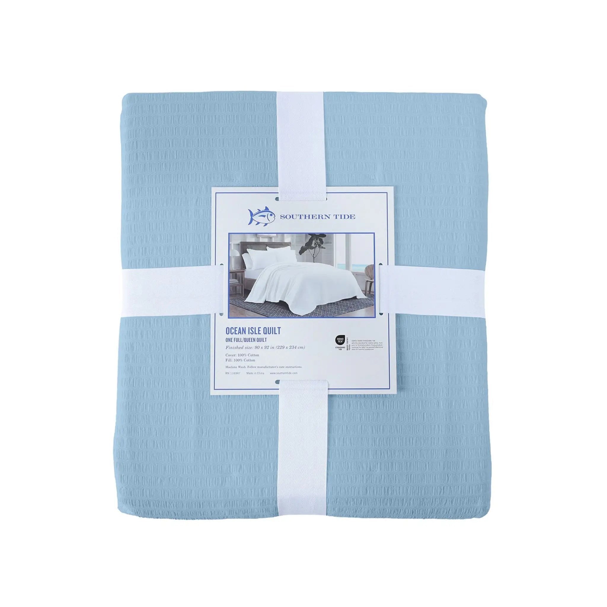 Blue quilt with a label on a white background