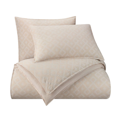 Beige patterned comforter set on a white background