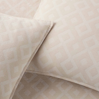 Close-up of beige textured fabric with geometric pattern