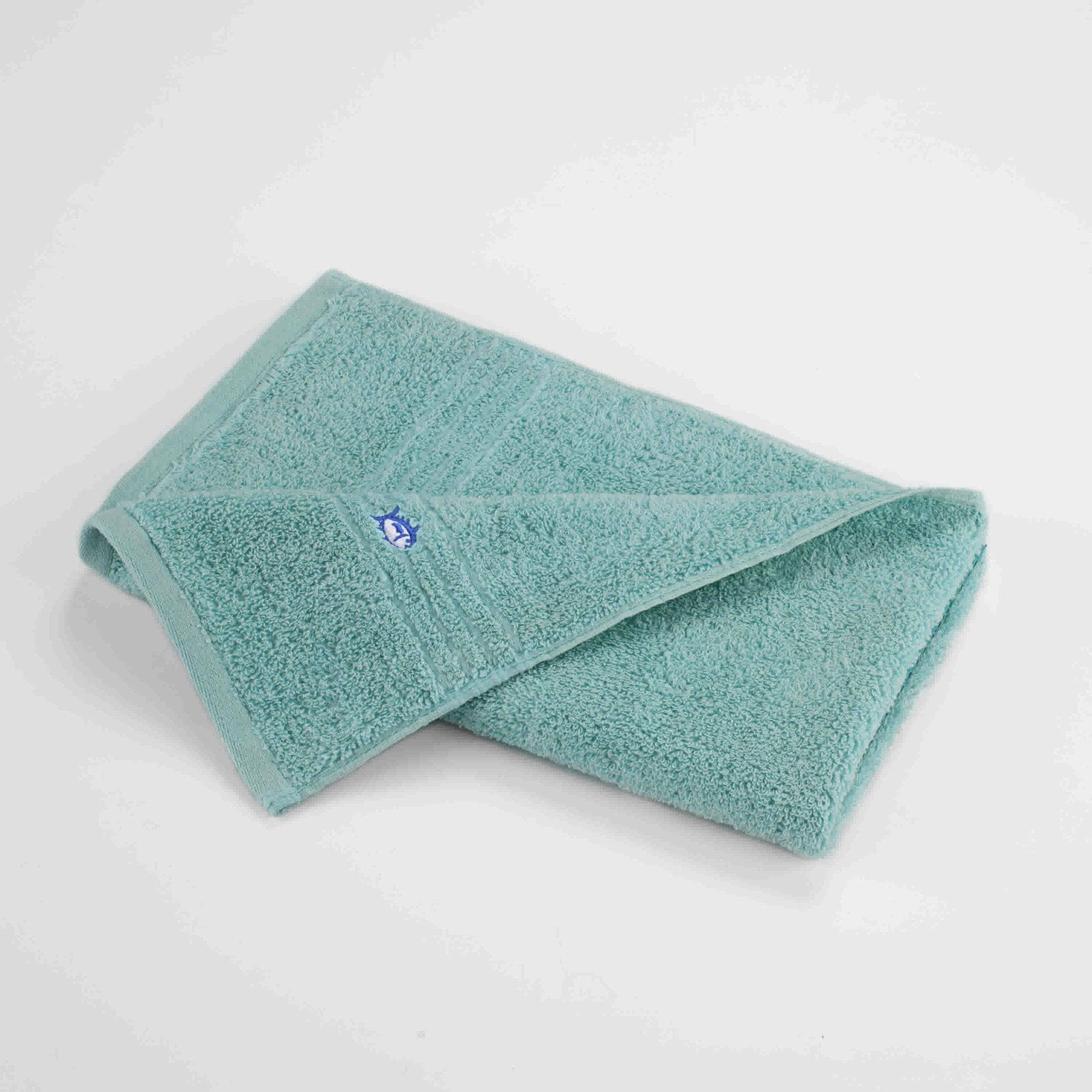 Folded aqua hand towel on a white background