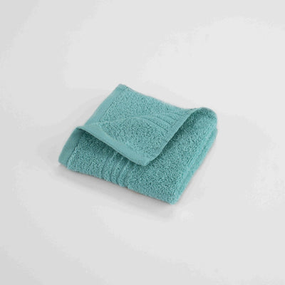 Aqua washcloth on a light gray background