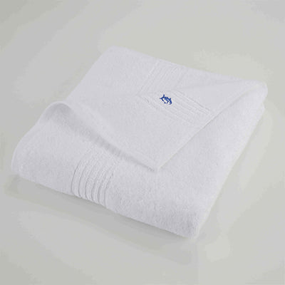 White bath towel with a blue logo on a light gray background