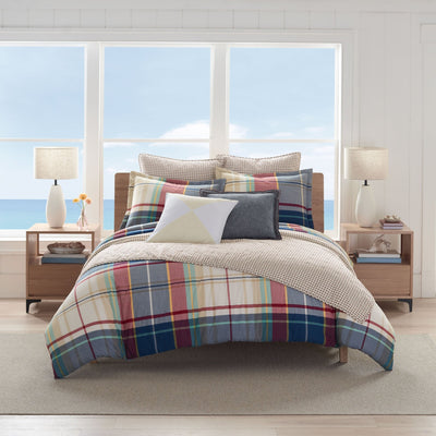 Bedroom with plaid bedding set.
