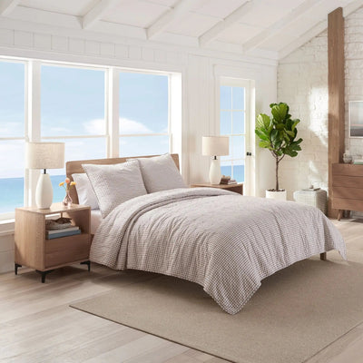 Modern bedroom with quilt and euro on a bed.