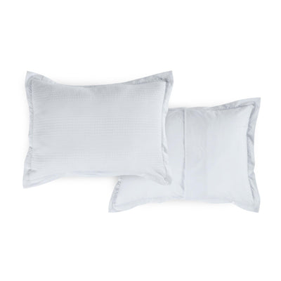 Two grey shams on a white background, featuring a subtle patterned front and a coordinating reversible side.