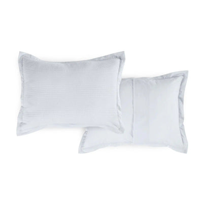 Two grey pillow shams with a subtle pattern on a white background