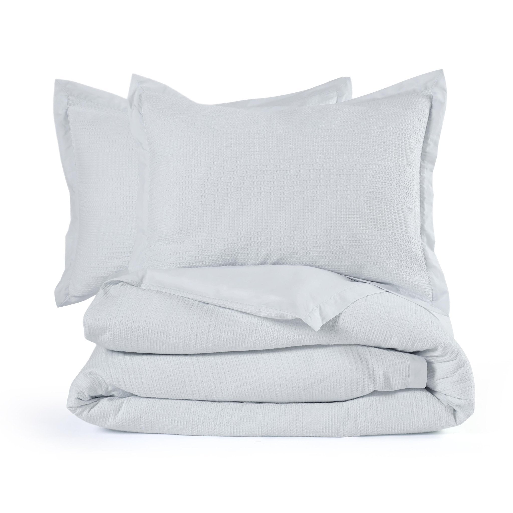 Light gray comforter set with two on a white background