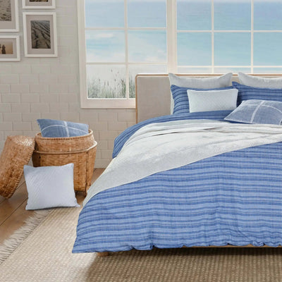 Bedroom with blue striped bedding.