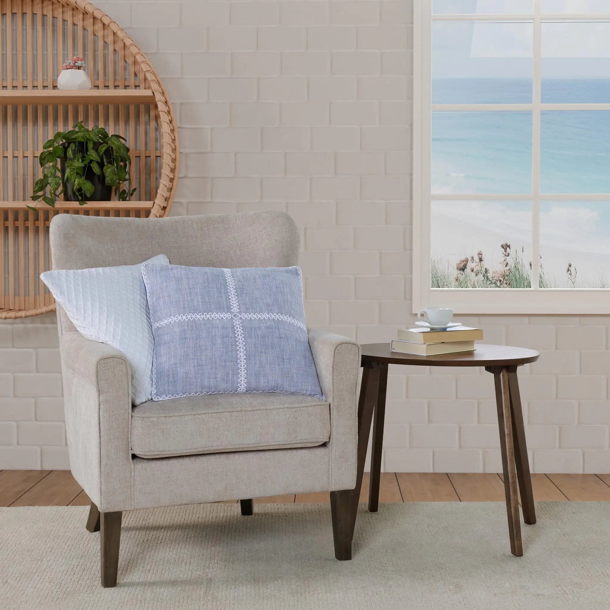 Beige armchair with blue checkered pillow in a room.