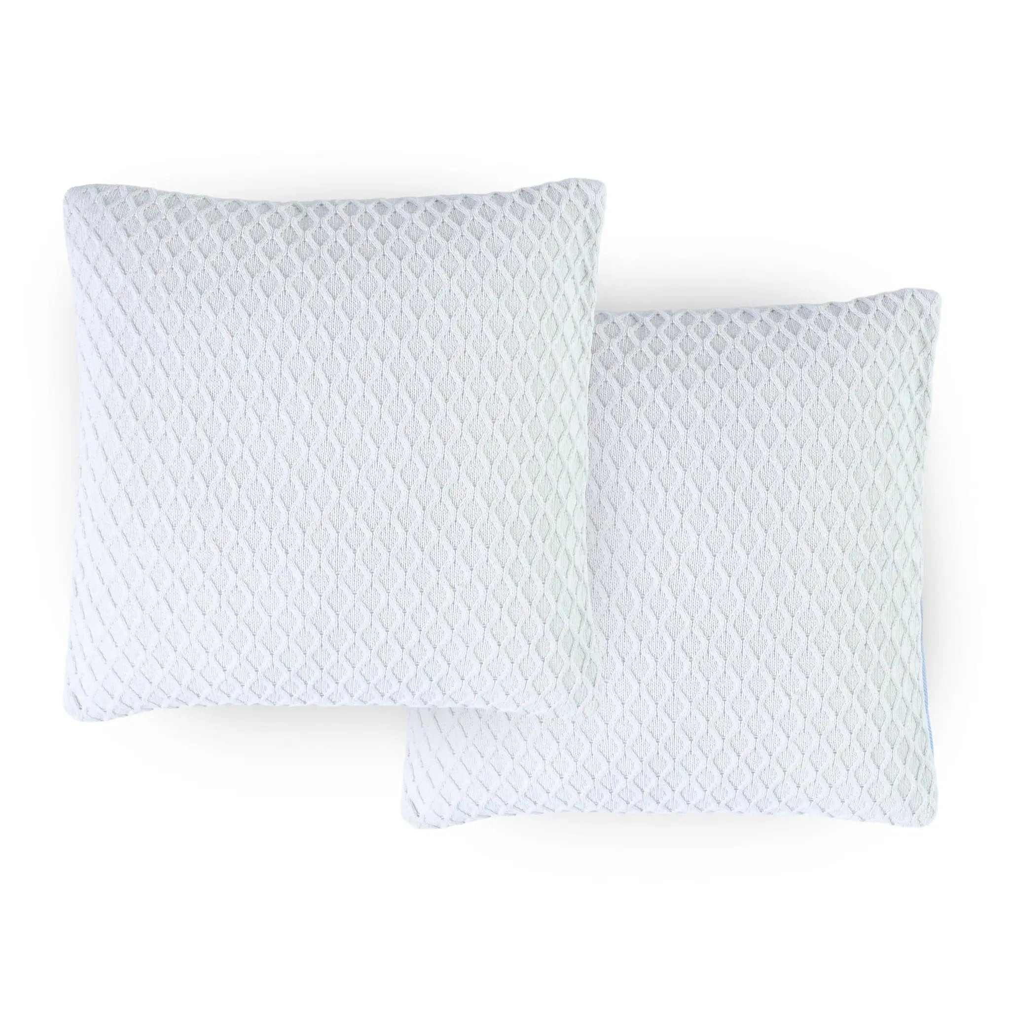 Two quilted white pillows on a white background