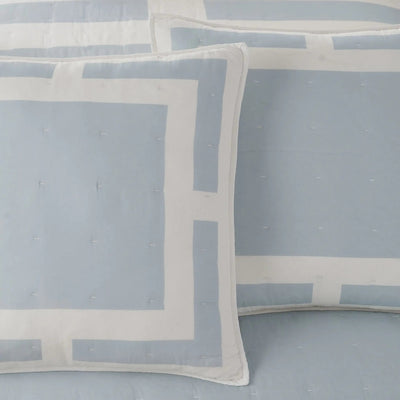 Light blue and white geometric patterned bedding set with matching euros, featuring subtle tufted stitching.