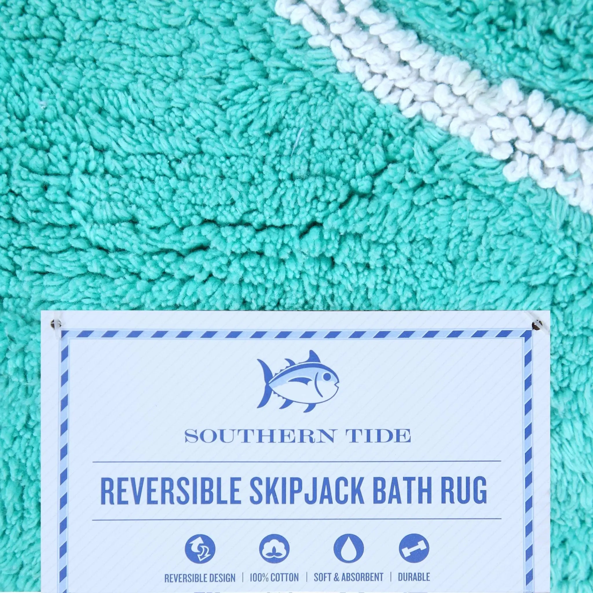 Reversible Skipjack bath rug with Southern Tide label on an aqua bath rug.