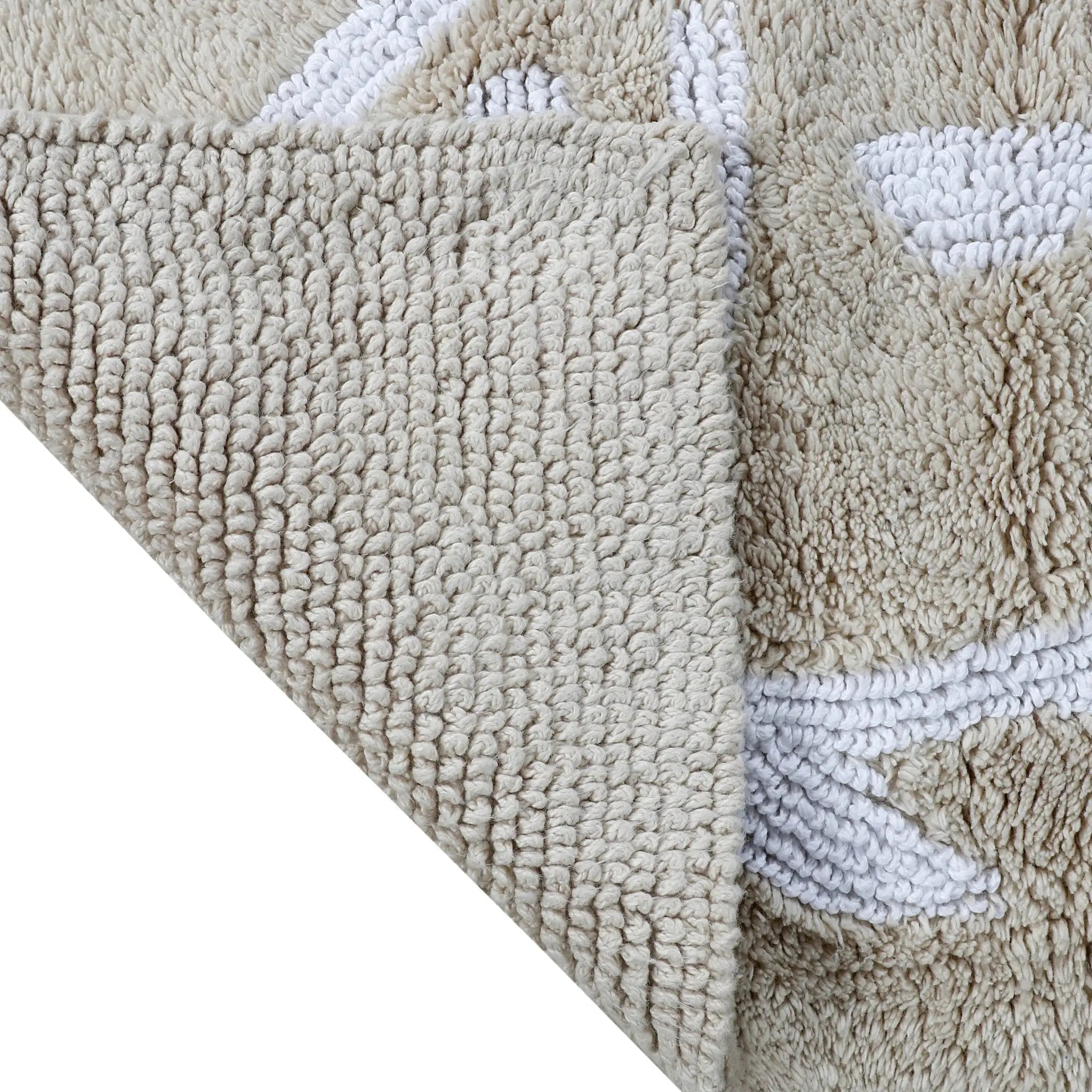 Close-up of a textured sand rug with a white border