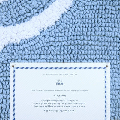 Light blue textured rug with a label in the center