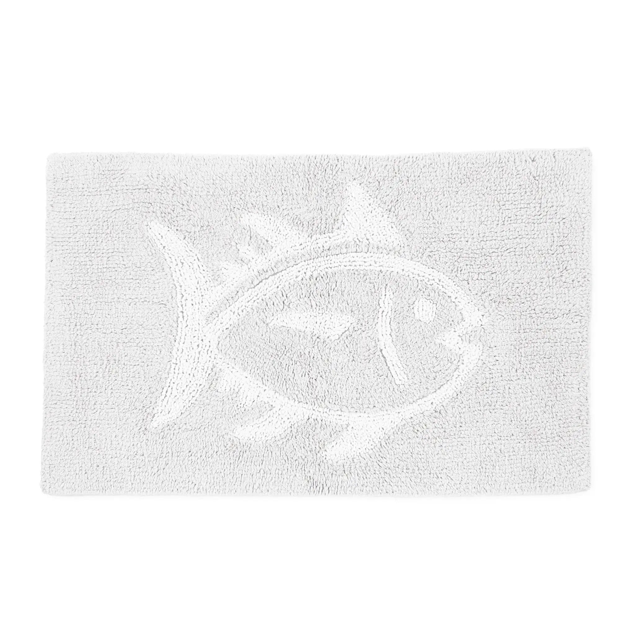 A white textured bath rug featuring a raised fish motif in the center, shown against a plain white background.