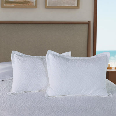 Two white shams on a bed.