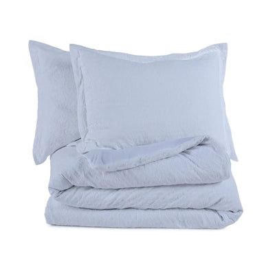 White comforter set on a white background