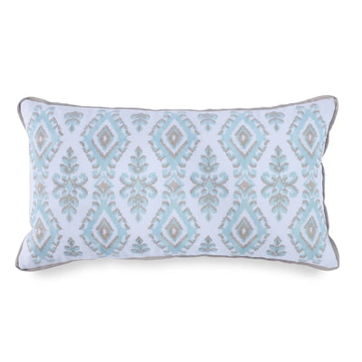 A rectangular lumbar throw pillow featuring a light blue and beige ikat diamond pattern on a white background, finished with a gray piped edge.