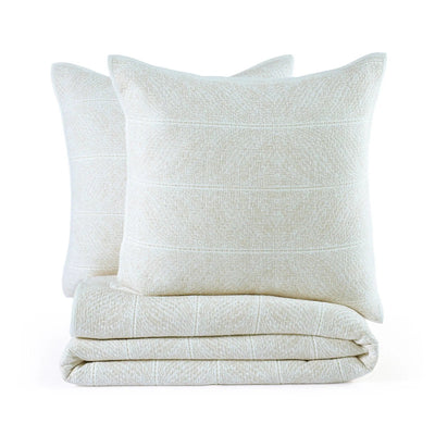 A set of white color quilt and euros on a white background.