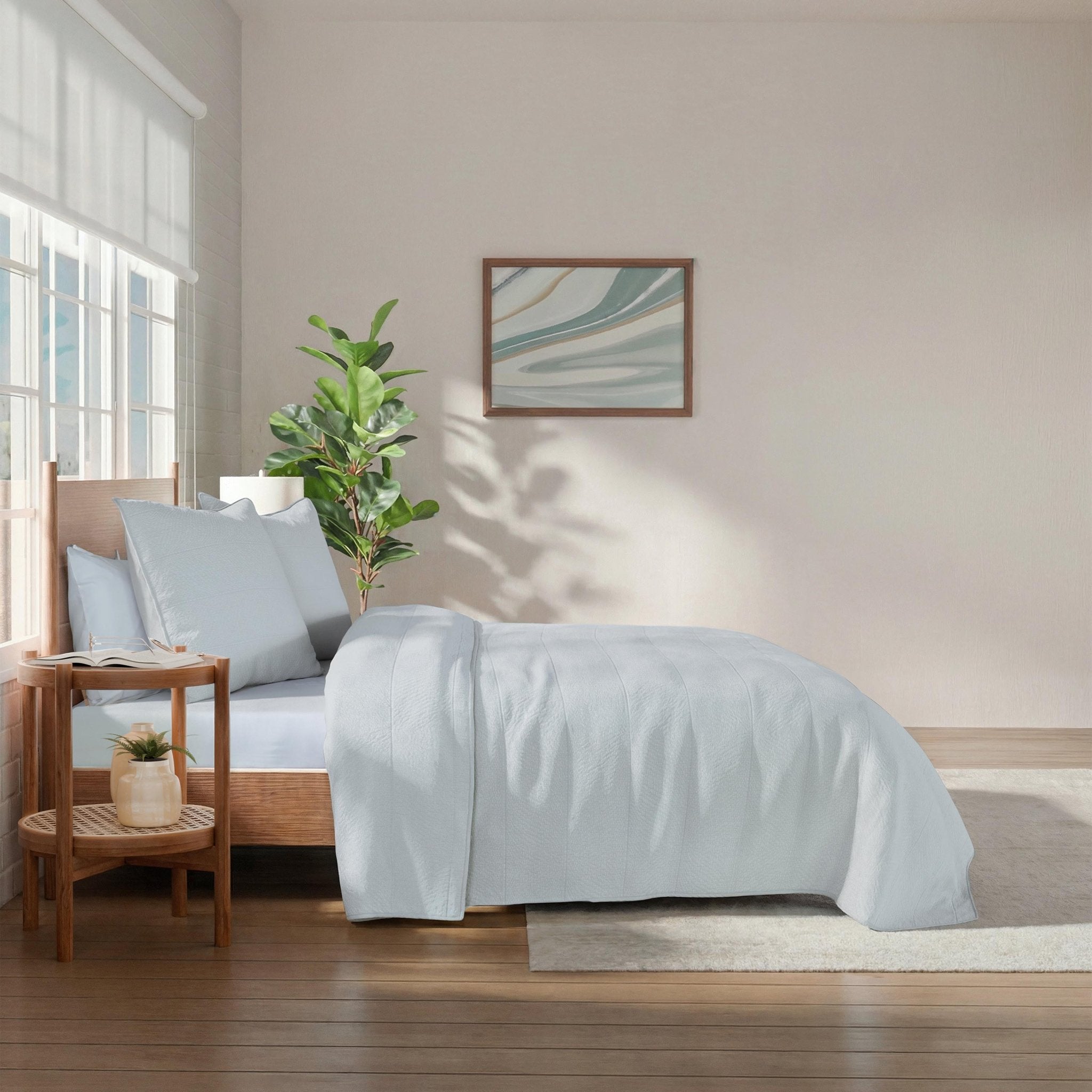 Bedroom with a bed covered in light blue bedding.