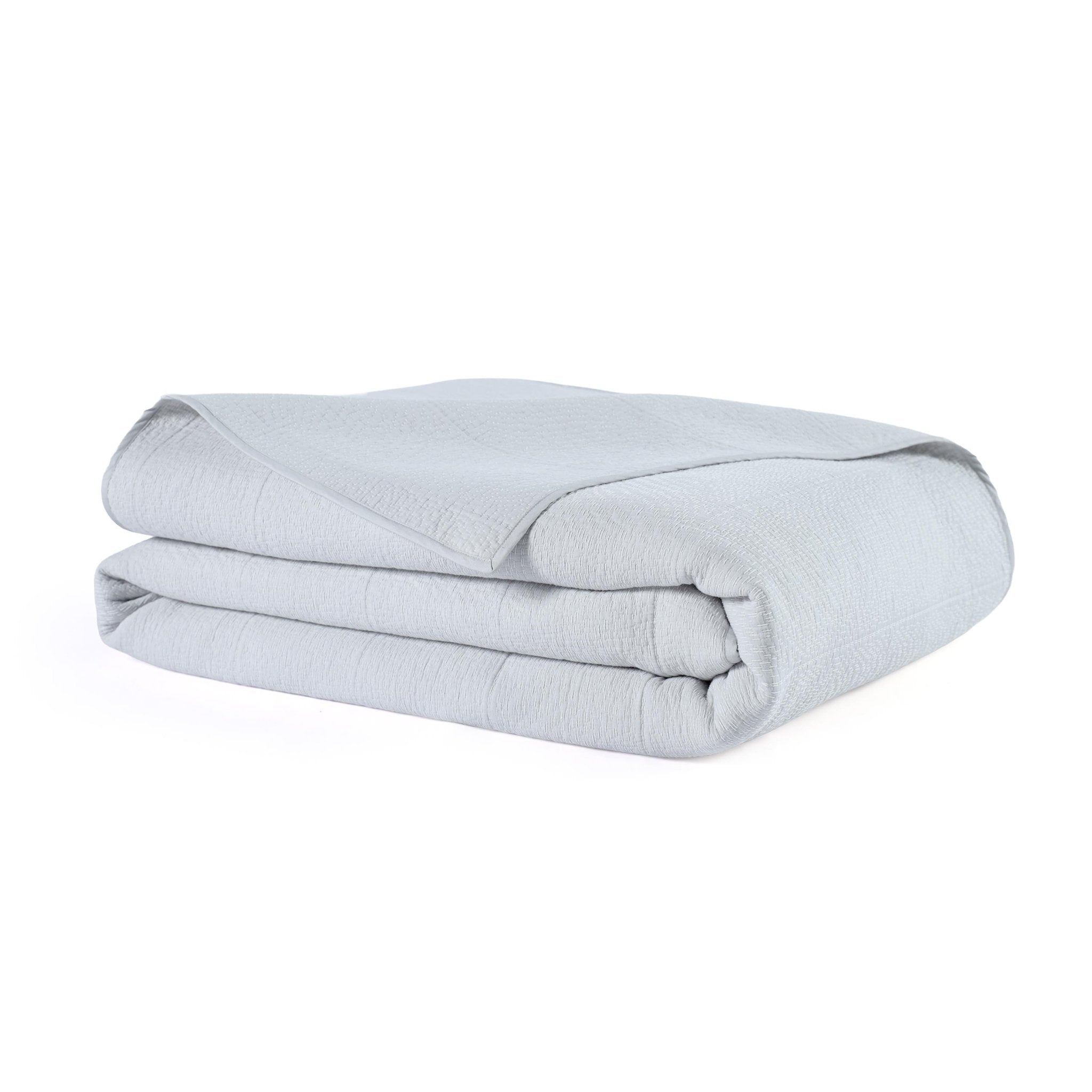 Folded light gray Quilt on a white background