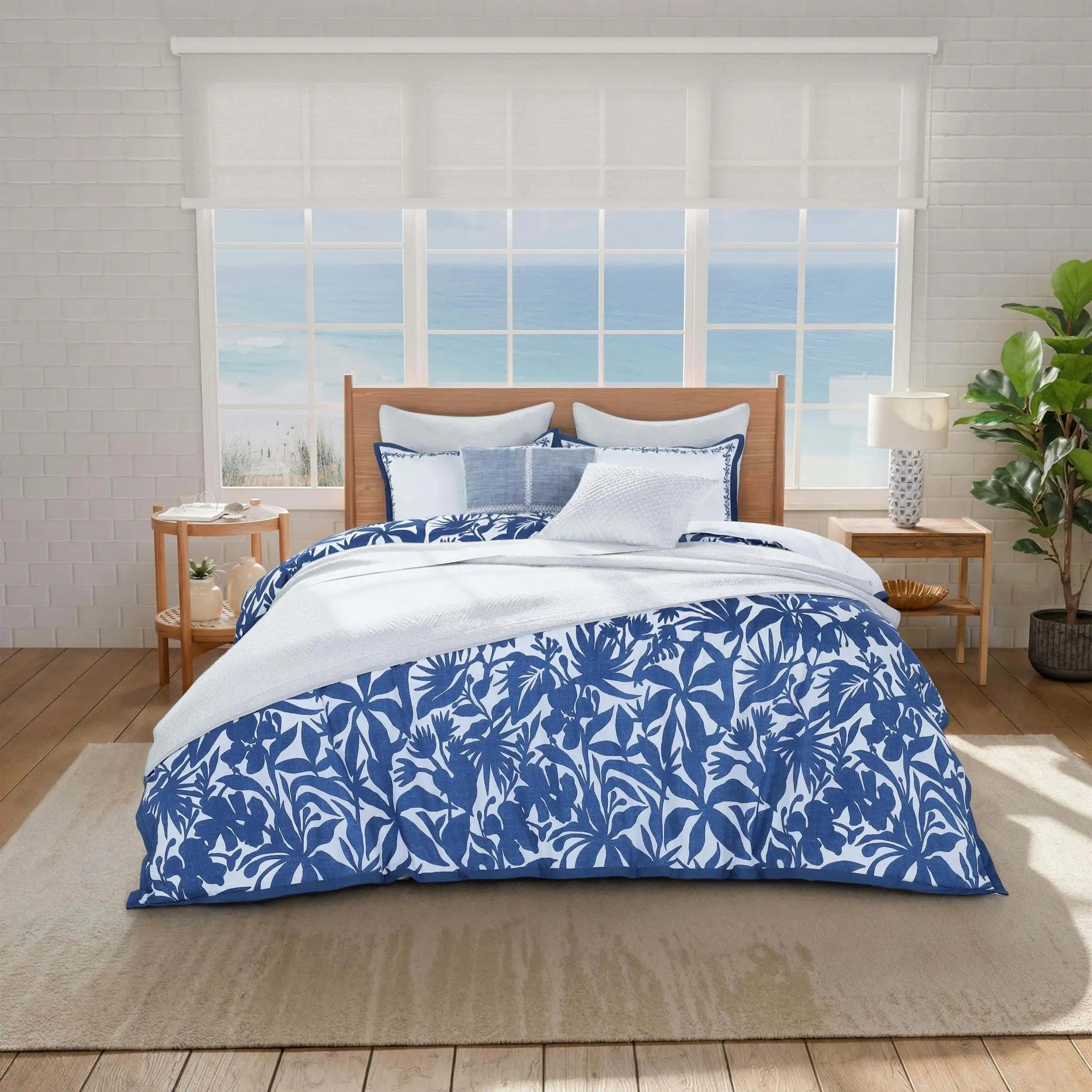 Bed with blue quilt and pillow shams.