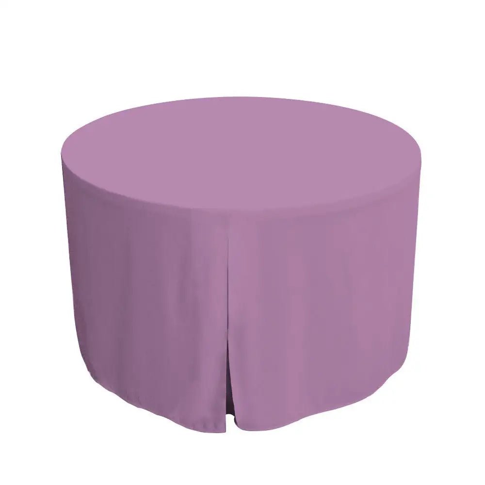 Round table covered with a lilac tablecloth on a white background