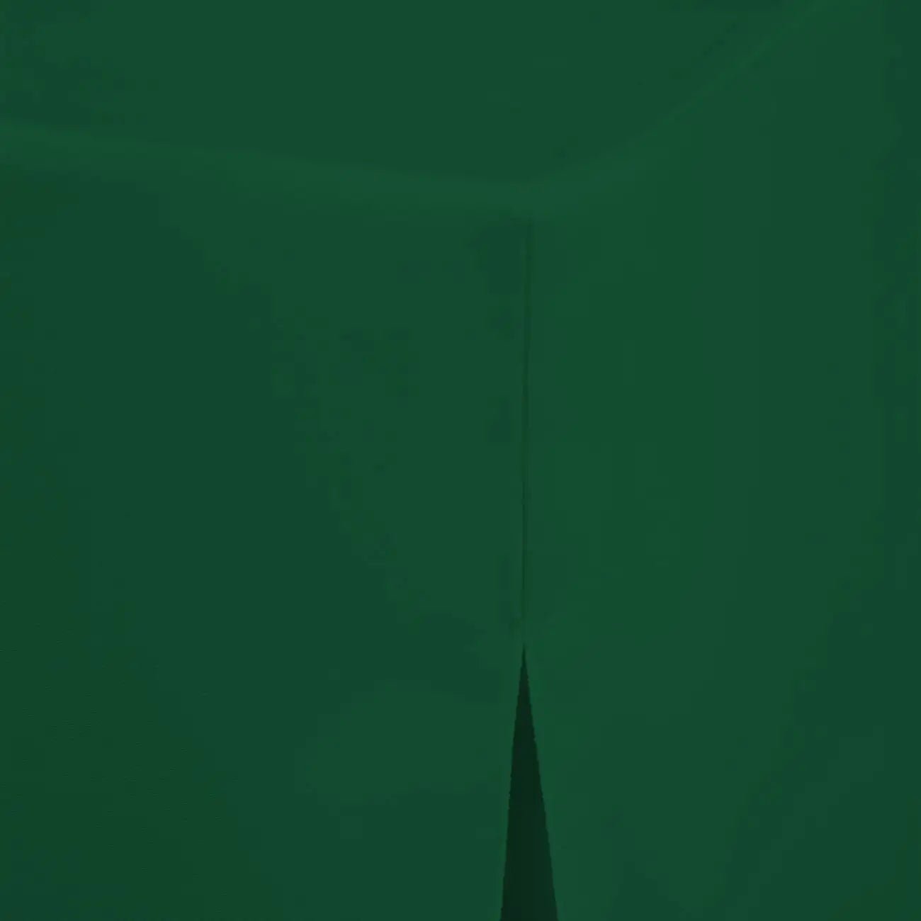 A close-up of dark forest green fabric with a subtle sheen and a faint vertical seam.