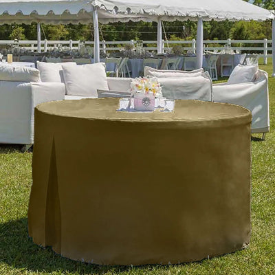 Round table covered with a brown tablecloth in an outdoor setting with chairs and a tent in the background.