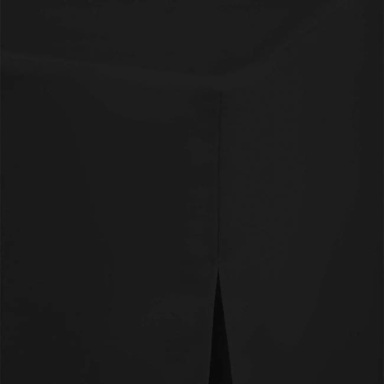 A close-up of a black fabric surface with a subtle V-shaped seam running vertically near the center.