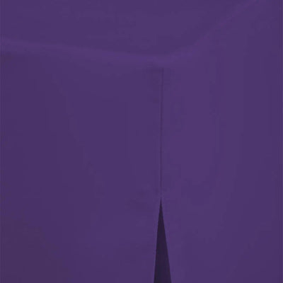 A close-up of a solid violet fabric surface with a visible fold or crease running vertically near the center.
