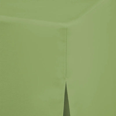 A close-up of a pistachio color fabric, showing the texture and a folded corner seam.