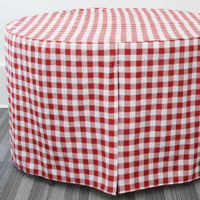 Round table cover covered with a red and white checkered fabric on a gray floor.