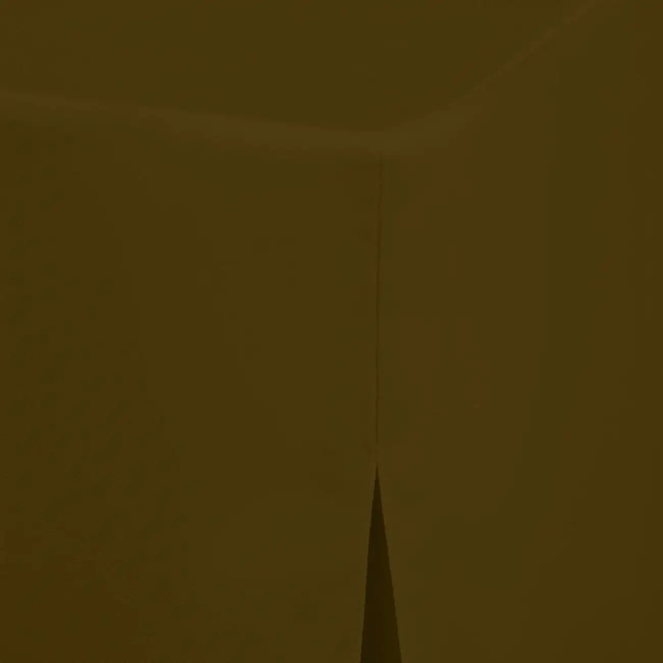 A close-up of a dark olive brown fabric table cover surface with a vertical seam and a small triangular fold at the bottom center.