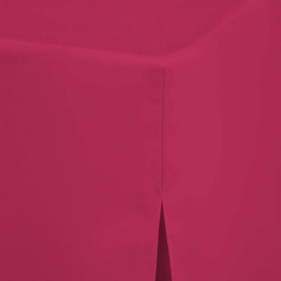 A close-up of a solid fuchsia colored material with a subtle texture and a vertical seam running down the center.