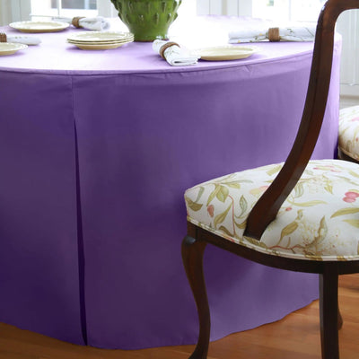 Voilet tablecloth on a dining table with a chair in the foreground