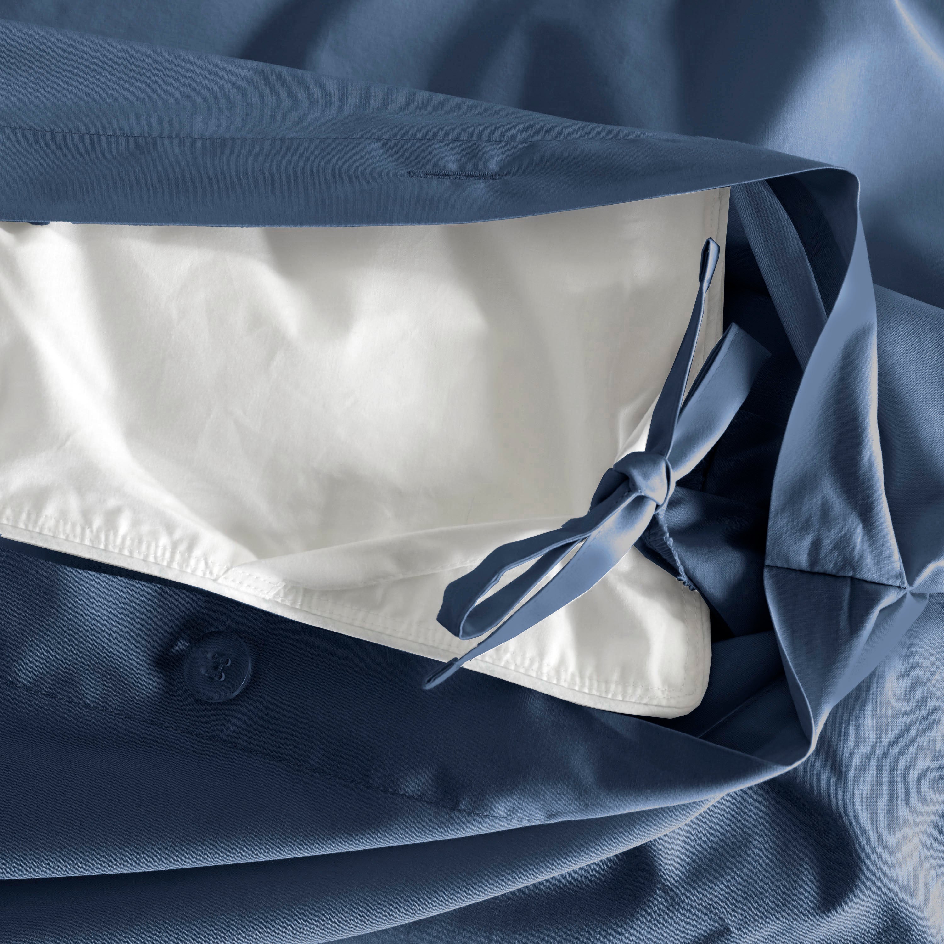 Duvet set featuring a blue exterior with a white interior and a tied closure detail.